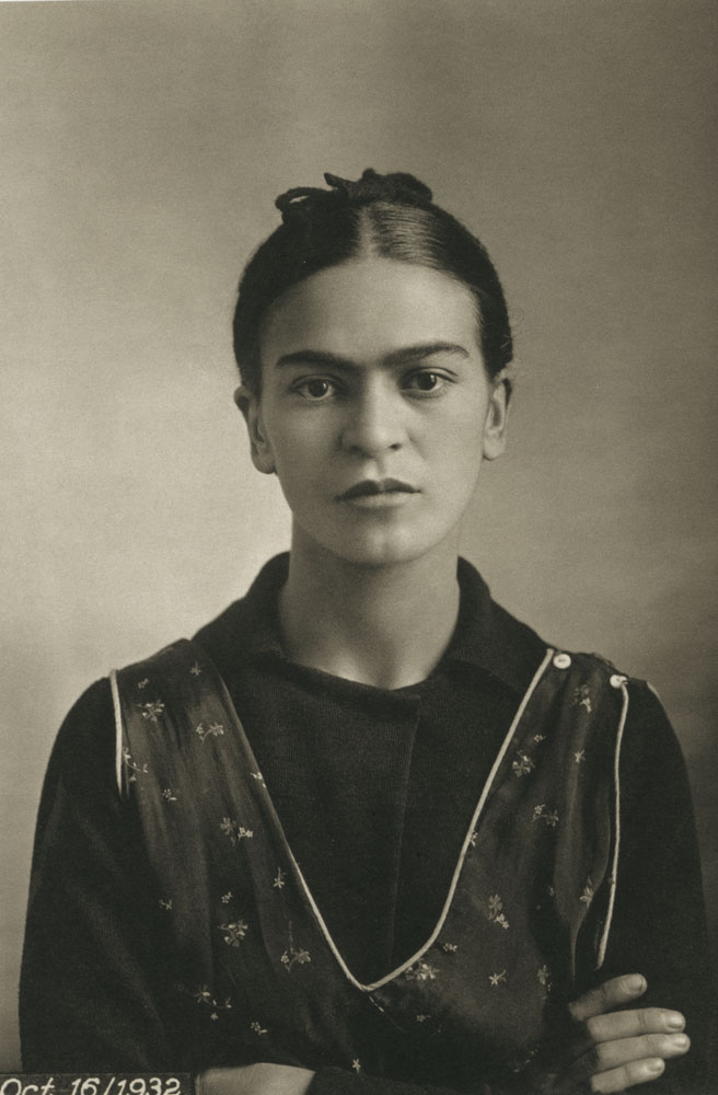 Portrait of a woman with a light skin tone wearing a floral dress.