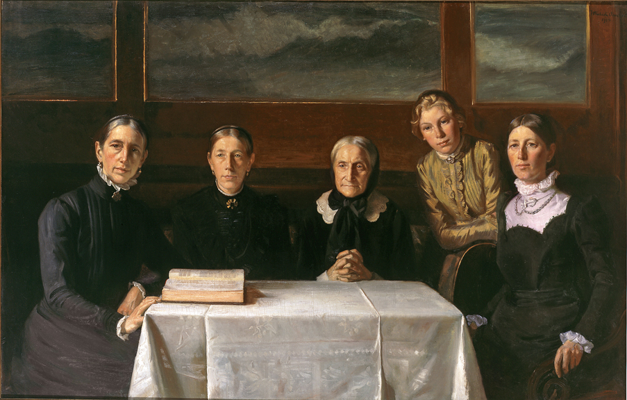 Portrait of five women in black dresses sitting by a table with a white tablecloth.