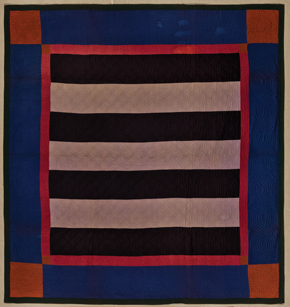 A blue, black, red, and white quilt with a bar pattern.