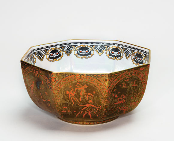 Photograph of a bowl painted in red and gold, depicting a medieval scene.