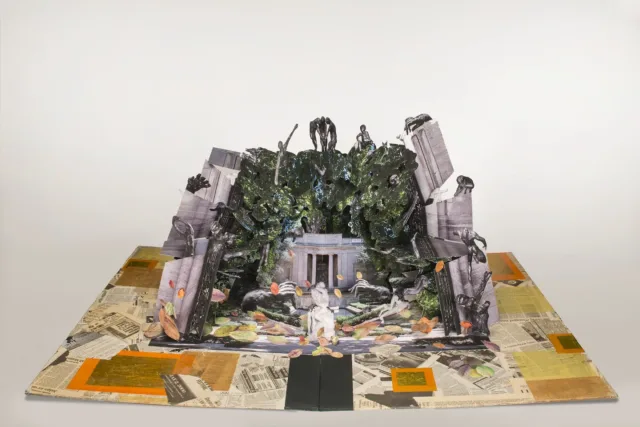 Large-scale pop-up book with Auguste Rodin's and Camille Claudel's sculptures in a deconstructed classical building. Sculptures populate a mass of greenery that overtakes the building, bordered by crumbling columns. Scattered petals of color match the collaged newspaper base.