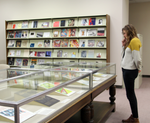 A visitor studies broadsides in the NMWA Library and Research Center.