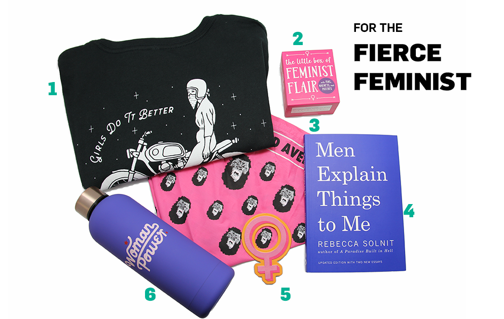 A photograph consisting of six objects arranged against a white background. The objects are a black T-shirt that says "Girls Do it Better," a purple water bottle that says "woman power," a magnet shaped like the symbol of Venus, a book titled "Men Explain Things to Me," a pink bandana with gorilla faces printed on it, and a pink box that says "The Little Box of Feminist Flare" on it.