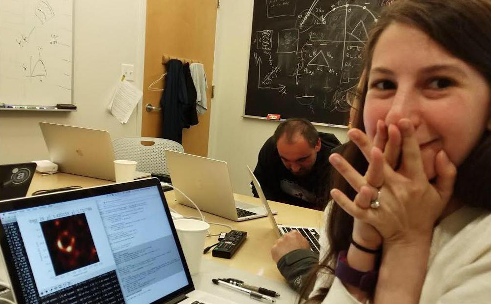 Katie Bouman watches a computer screen excitedly as the first image of a black hole is created with the algorithim she helped write.