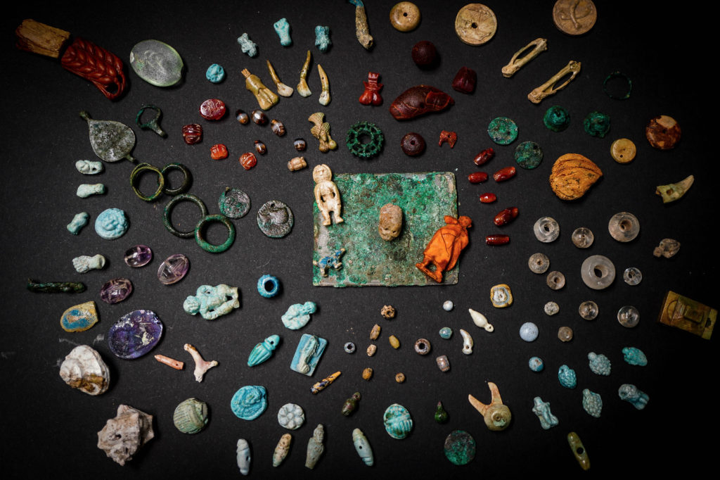 More than 100 miniature dolls, phallic amulets, necklace beads, and a tiny skull among other objects made of bone, bronze, glass, and amber were uncovered at Pompeii.