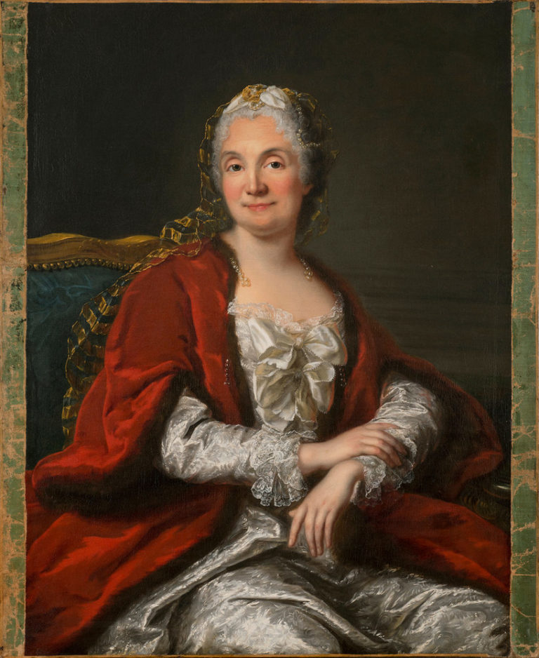 A light-skinned, gray-haired woman appears from the waist up, sitting with arms crossed loosely in her lap. Her body turns to her left, but she faces the viewer offering a slight smile and making eye contact. Her white satin gown and fur- and pearl-trimmed red cape imply wealth.