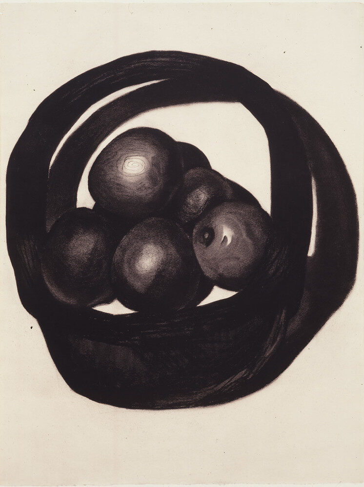A still life of avocados in a basket rendered in charcoal on a white ground uses radically simplified forms. Two offset circles evoke a basket and its shadow. Within the circles, ovals highlighted to imply 3 dimensions, seem to hover above, not sit within, the basket interior