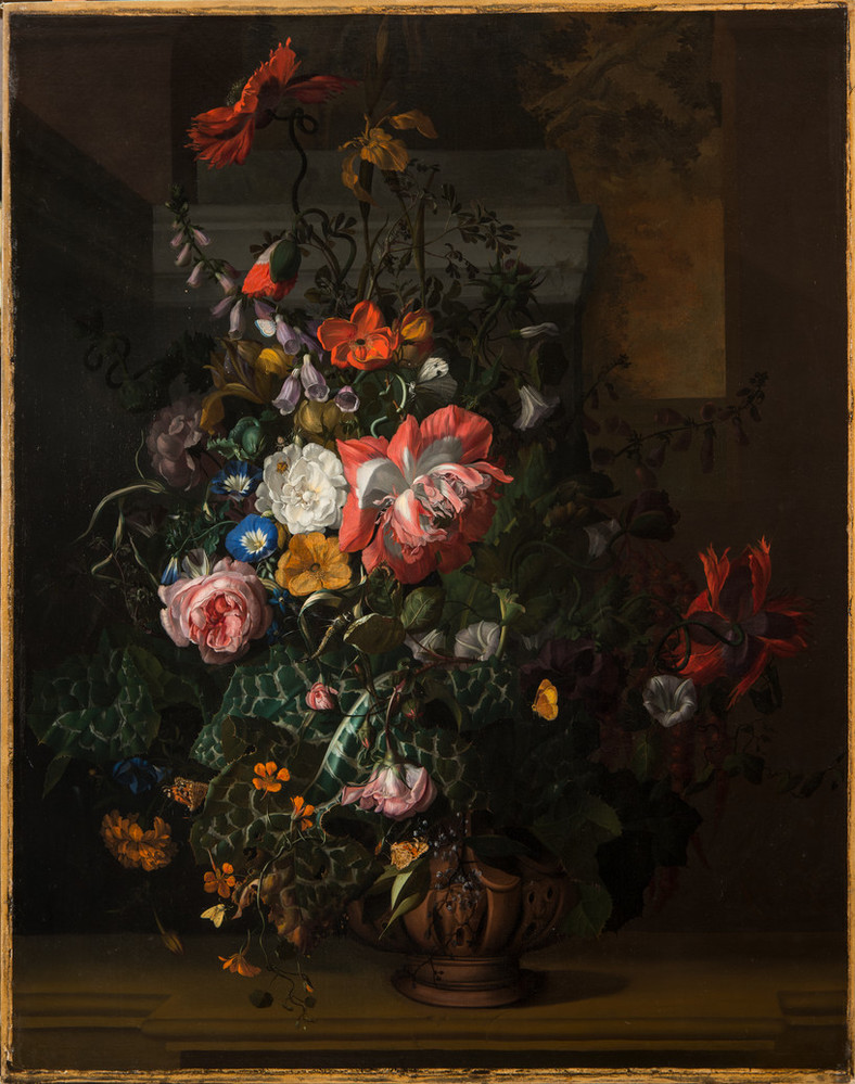 An elaborate floral arrangement painted with precise detail appears dramatically spot lit against a dark background. Large red and pink blooms dominate, interspersed with small yellow, white, and blue blossoms and varied foliage. Moths and other insects animate the bouquet.