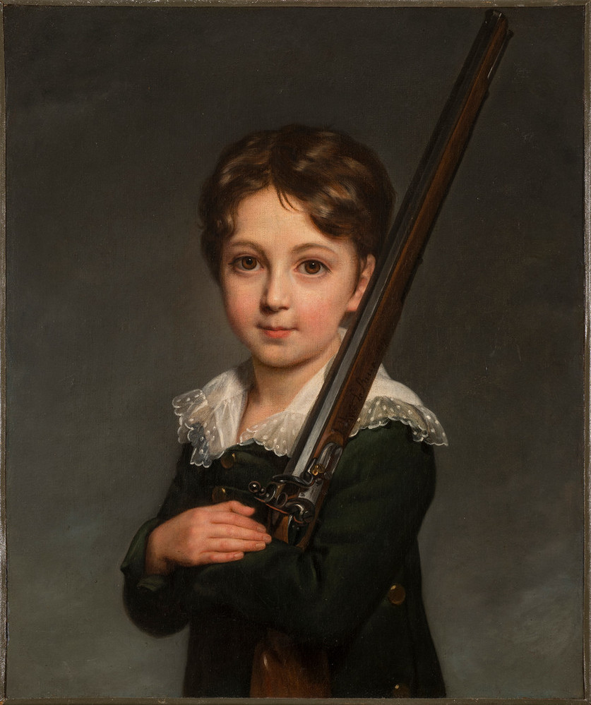A young boy with light skin and brown hair faces the viewer while cradling the stock of a rifle in his arms and resting the barrel on his left shoulder. He wears a delicate lace collar and is shown against a gray background with visible brushstrokes.