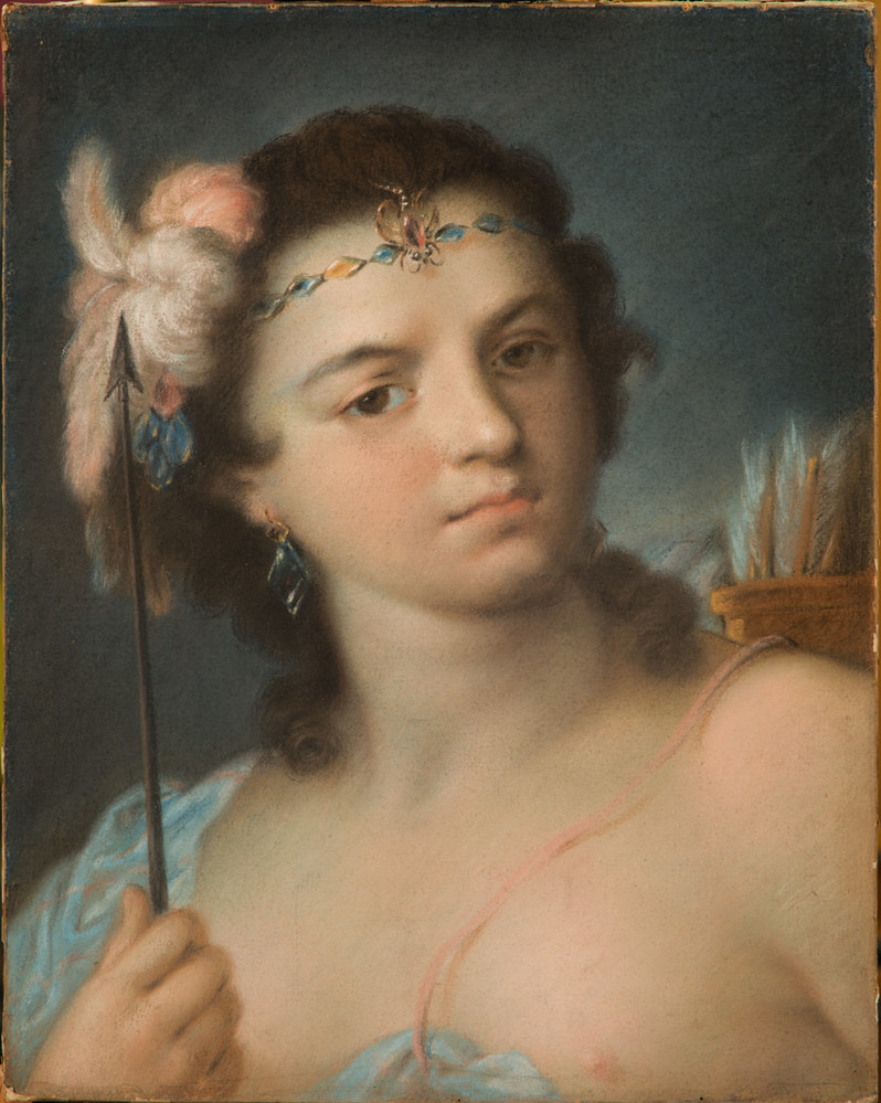 A woman with light-skin and brown hair stands slightly angled and stares straight out to the viewer. In her right hand, she holds an upward-pointing arrow and carries a quill of bows on her back. She wears light feathers in her hair and a delicate jeweled crown.