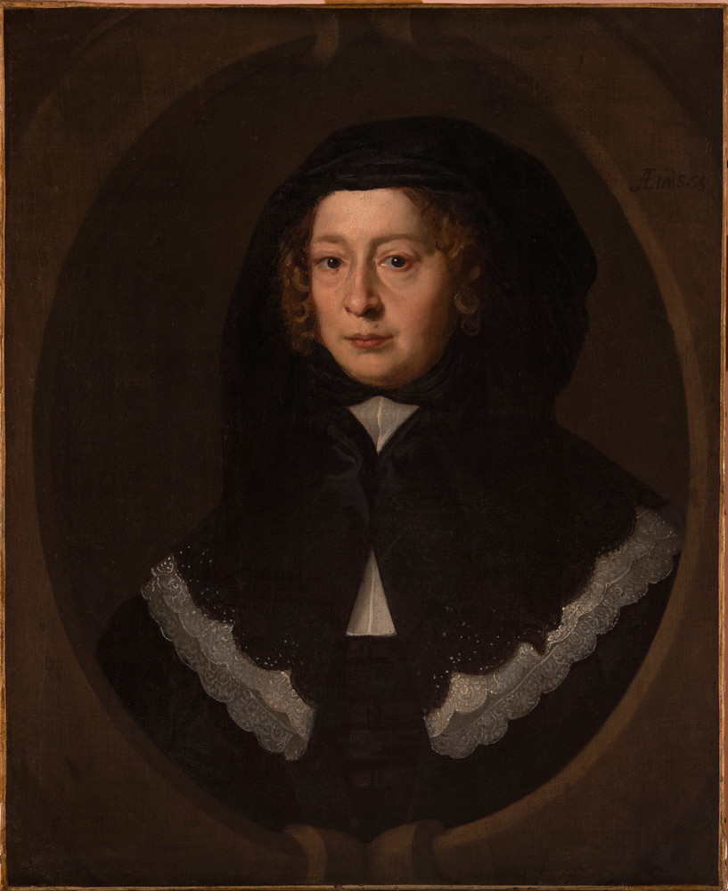 Oval-shaped portrait of a light-skinned woman with short dark curls. Dressed in black with white lace details, a black hood covers her head. Her brown eyes gaze directly at the viewer, her expression slightly tense.