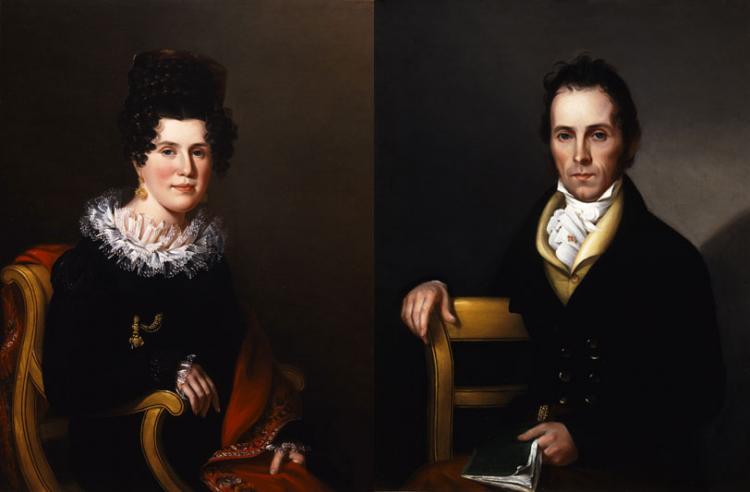 Side-by-side portraits of a light-skinned couple with dark hair sitting in formal postures. Gazing outward, they wear dark clothing with light accents and the woman wears a gold earring and pin. They both hold objects: the woman a brocaded red cloth and the man a book.