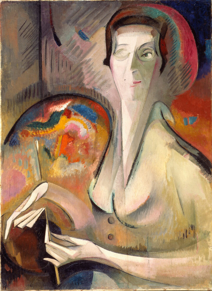 Dynamic painting features a backdrop of red, orange, and blue hues. The artist's face, hands, and body are composed of conjoined geometric and organic shapes in a neutral color palette. Her left eye and hands are explicitly described, as is artist's palette on her right.