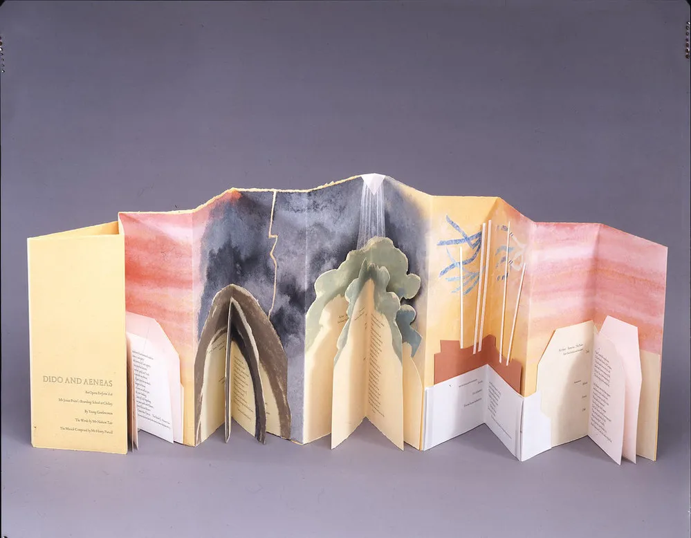 Accordion book of peach paper. Blocks of text, in geometric and organic-shaped boxes, occupy the lower half of the pages. Each block of text has additional folds, forming a mini-book. Above, warm colors fade into dark skies, trees, and ship masts, and then again into pink tones.