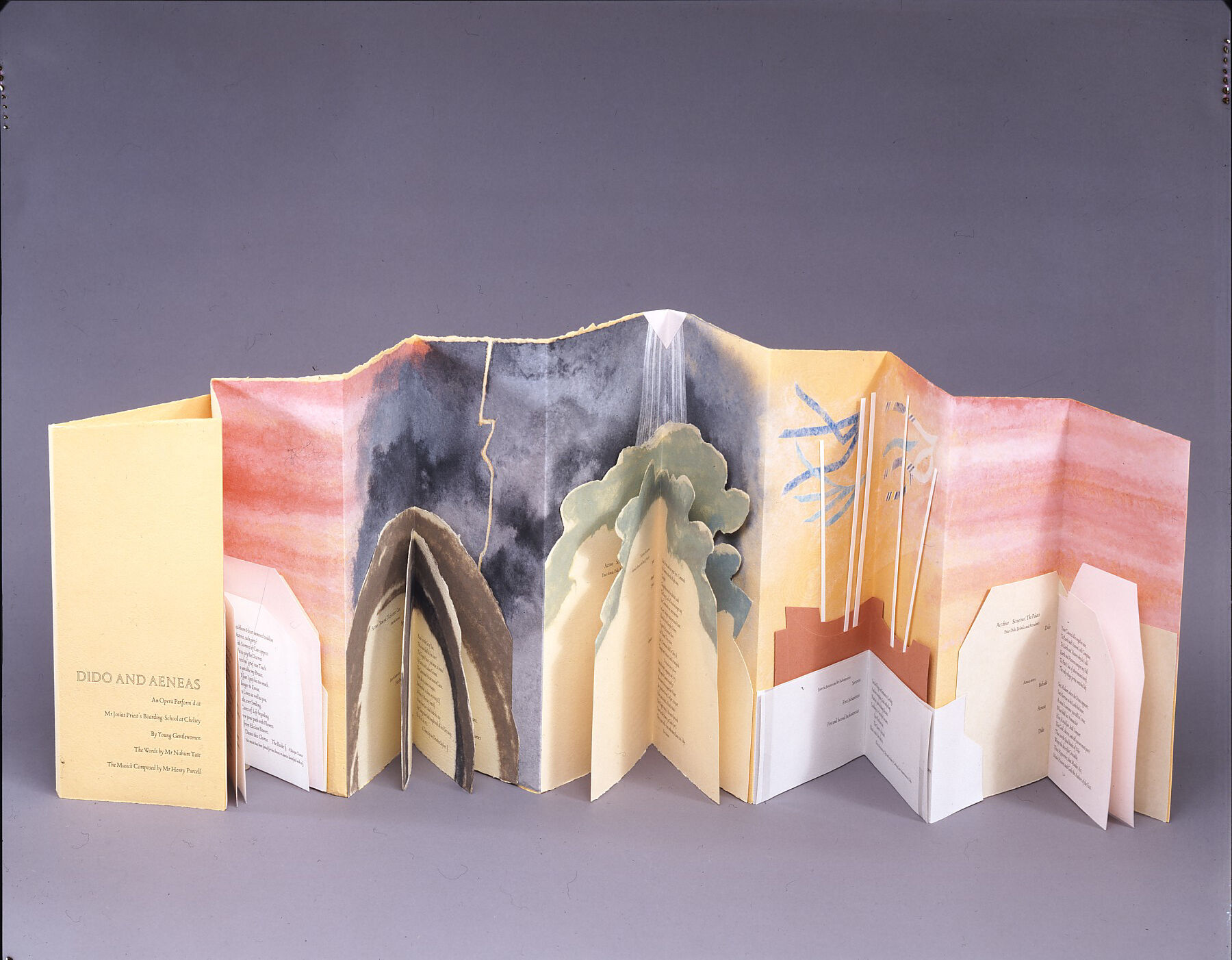 Accordion book of peach paper. Blocks of text, in geometric and organic-shaped boxes, occupy the lower half of the pages. Each block of text has additional folds, forming a mini-book. Above, warm colors fade into dark skies, trees, and ship masts, and then again into pink tones