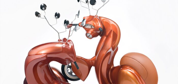 A sculpture consists of two metallic-orange motor scooters manipulated to resemble male deer. Leather seats become haunches, dashboard dials resemble faces, and multiple rear-view mirrors morph into antlers. The serpentine, hybrid animal-machines appear to spar for dominance.