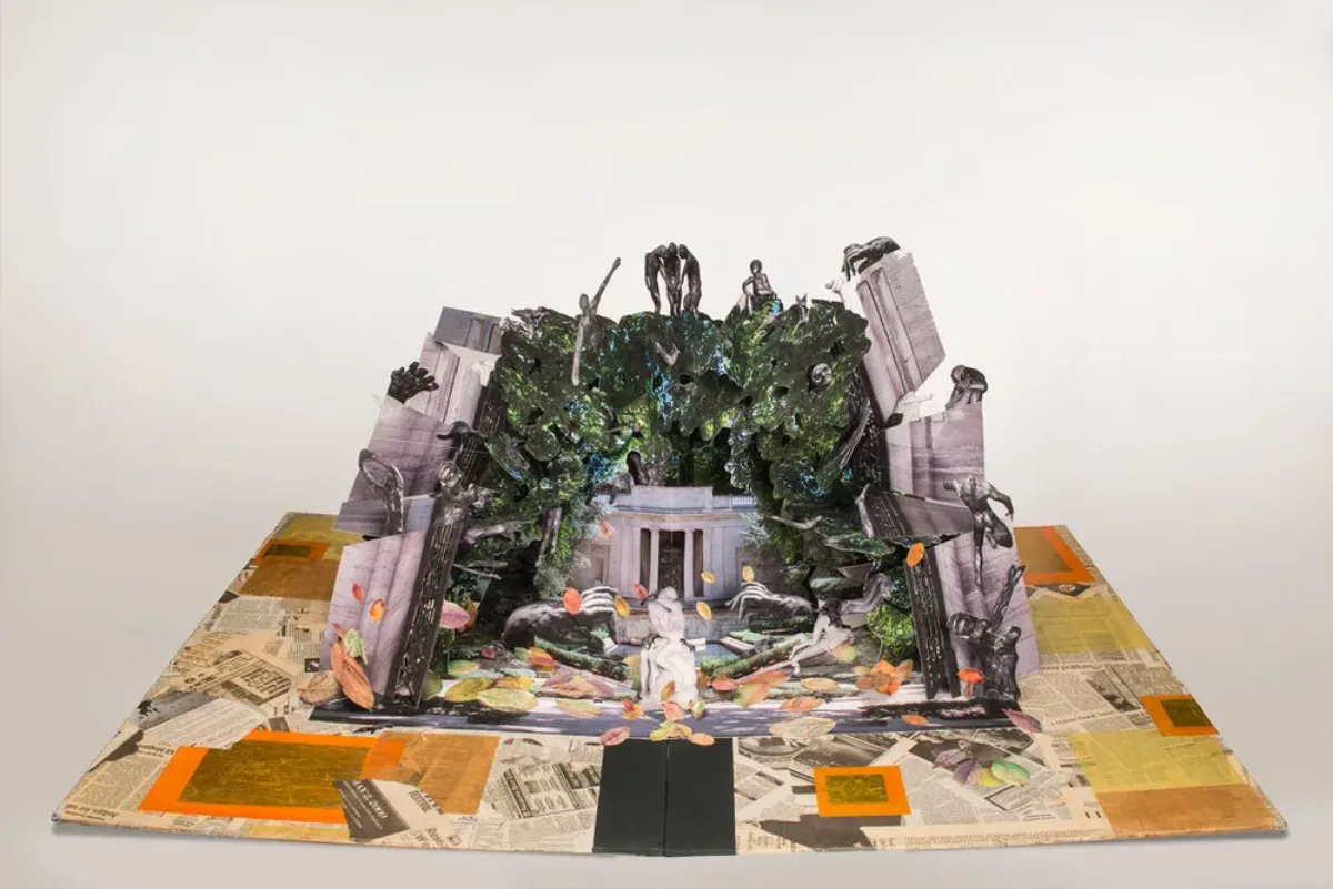 Large-scale pop-up book with Auguste Rodin's and Camille Claudel's sculptures in a deconstructed classical building. Sculptures populate a mass of greenery that overtakes the building, bordered by crumbling columns. Scattered petals of color match the collaged newspaper base.