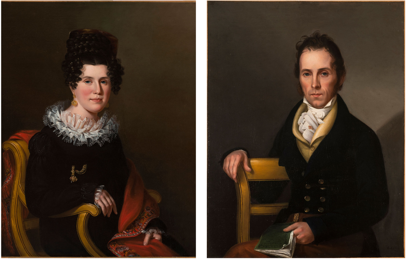 Side-by-side portraits of a husband and wife with light skin tone and dark hair sitting in formal postures. Gazing outward, they wear dark clothing with light accents and the woman wears a gold earring and pin. They both hold objects: the woman a brocaded red cloth and the man a book.