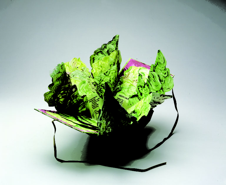 Artist's book resembling a salad in a bowl. Constructed of Tyvek that has been painted in swirling greens and map-folded to look like leaves of lettuce, there is poem written on the inner the leaves.