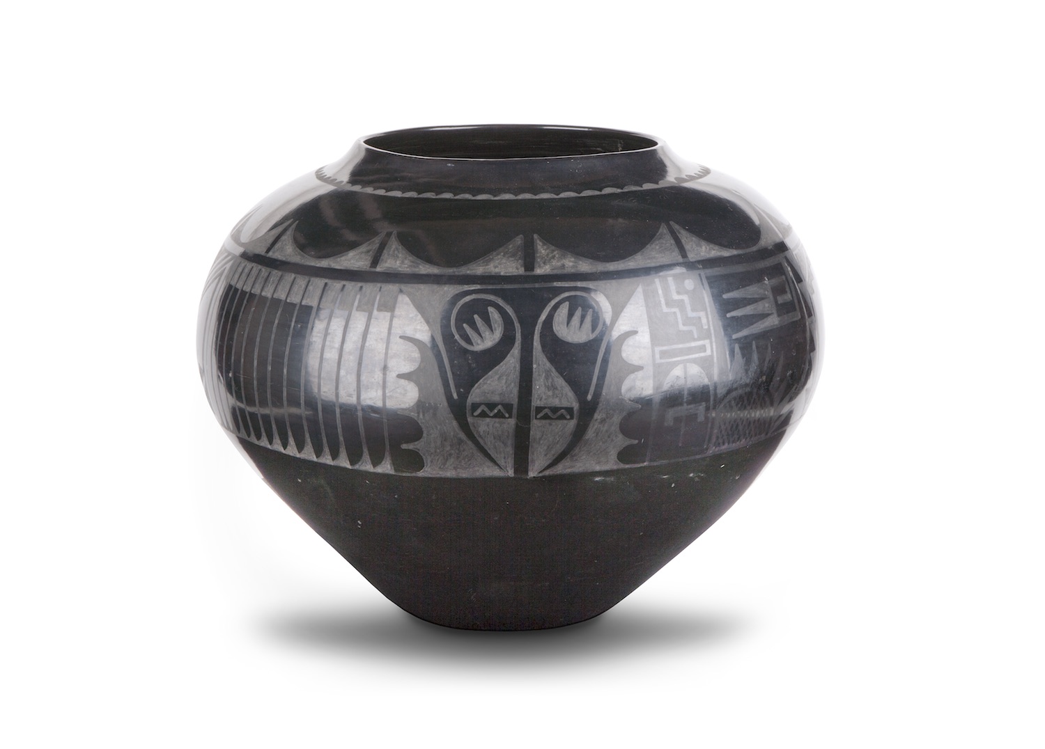 Blackware jar made of clay and volcanic ash. A painted, matte design adorns the upper half of the jar.