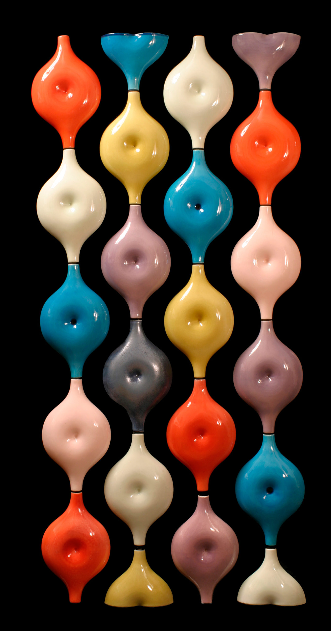 Round shapes with dimples in the middle that resemble the belly button from the human body in candy-colored glazes that are stacked in four vertical rows of to create S-shaped lines.