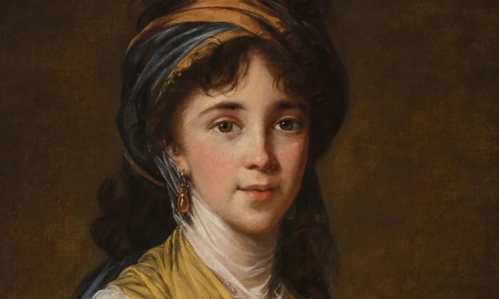 Realistically rendered half-portrait of a light-skinned young woman, gazing directly at the viewer with a faint smile on her lips. Her dark, curly hair is attractively tousled, secured under a turban-like headdress which matches her gold and blue draped ensemble.