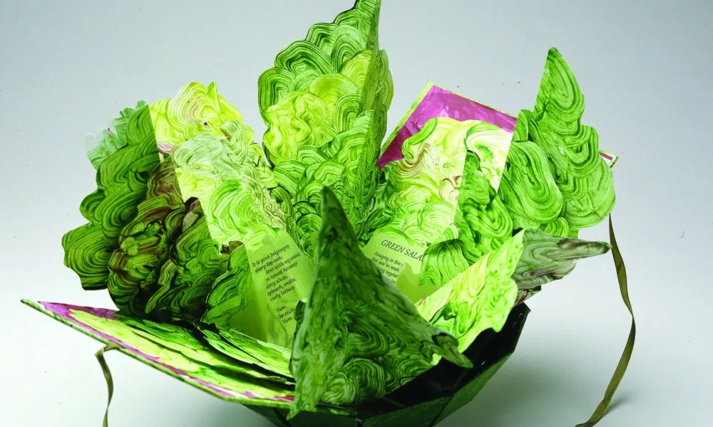 Artist's book resembling a salad in a bowl. Constructed of Tyvek that has been painted in swirling greens and map-folded to look like leaves of lettuce, there is poem written on the inner the leaves.