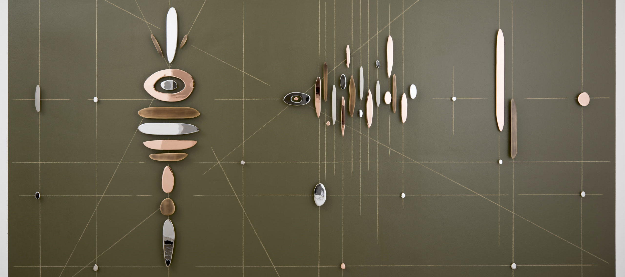 Abstract wall sculpture featuring horizontal, vertical, and diagonal intersecting lines overlaid with pieces of rounded, plated steel