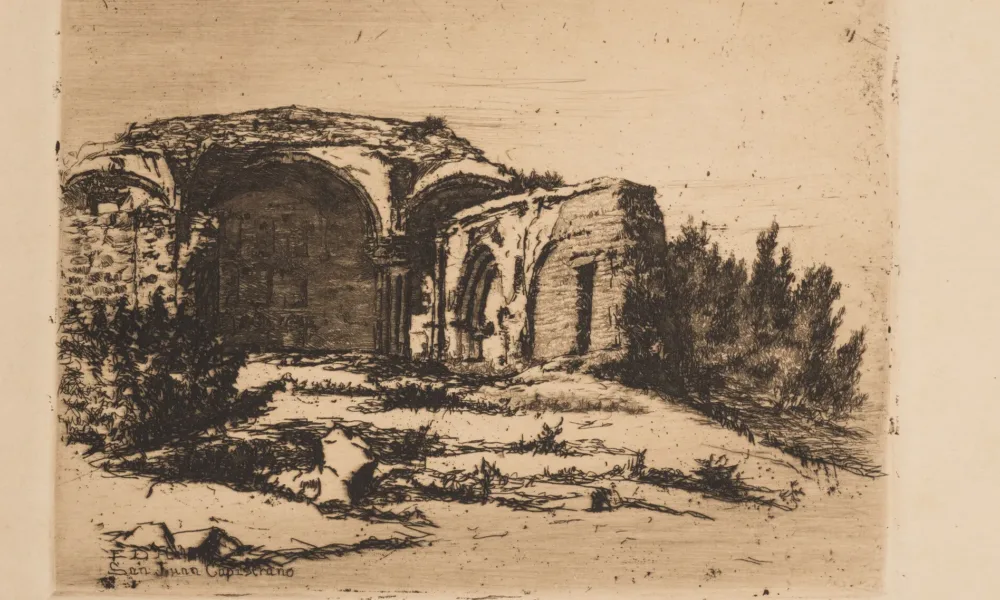 Small print of black ink on ecru paper depicting the ruins of an old Catholic mission building. The building, featuring rounded arches, crumbling facades, and exposed brick, is surrounded by scrub bushes and desert landscape.