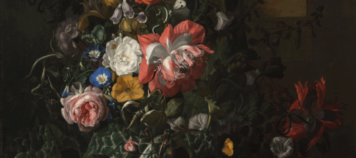 A still life painting featuring an asymmetrical arrangement of flowers; the central section features pink, orange, yellow, and blue flowers and is dramatically highlighted compared to the background and outer edge of arrangement.