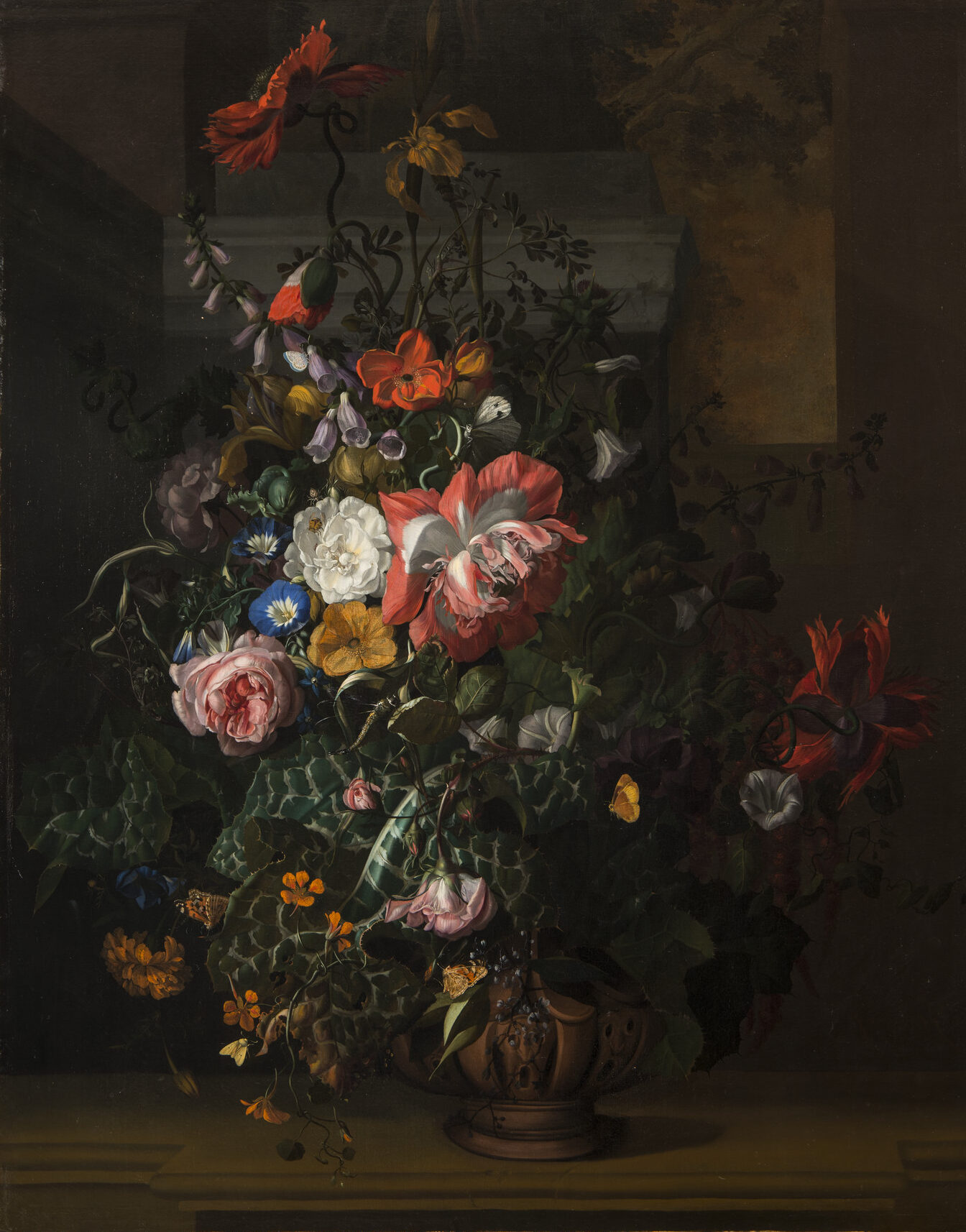 A still life painting featuring an asymmetrical arrangement of flowers; the central section features pink, orange, yellow, and blue flowers and is dramatically highlighted compared to the background and outer edge of arrangement.