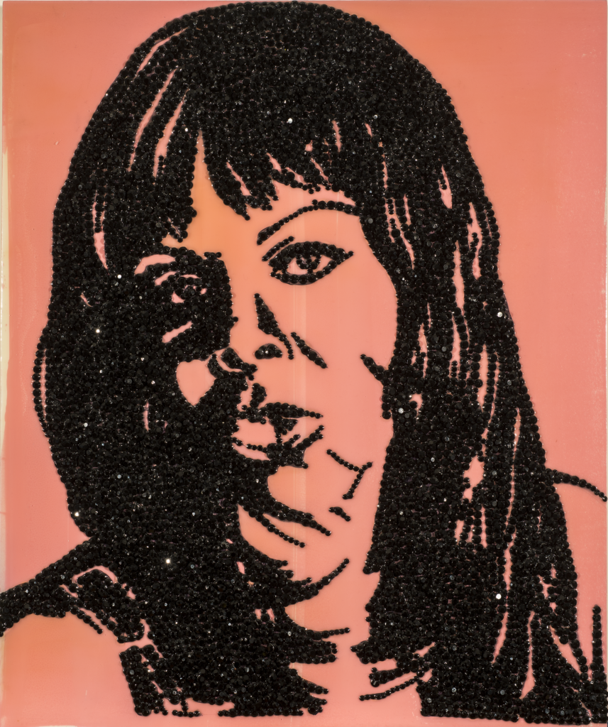 An enamel portrait painting of a woman made with encrusted black rhinestones glued to shiny pink acrylic background.