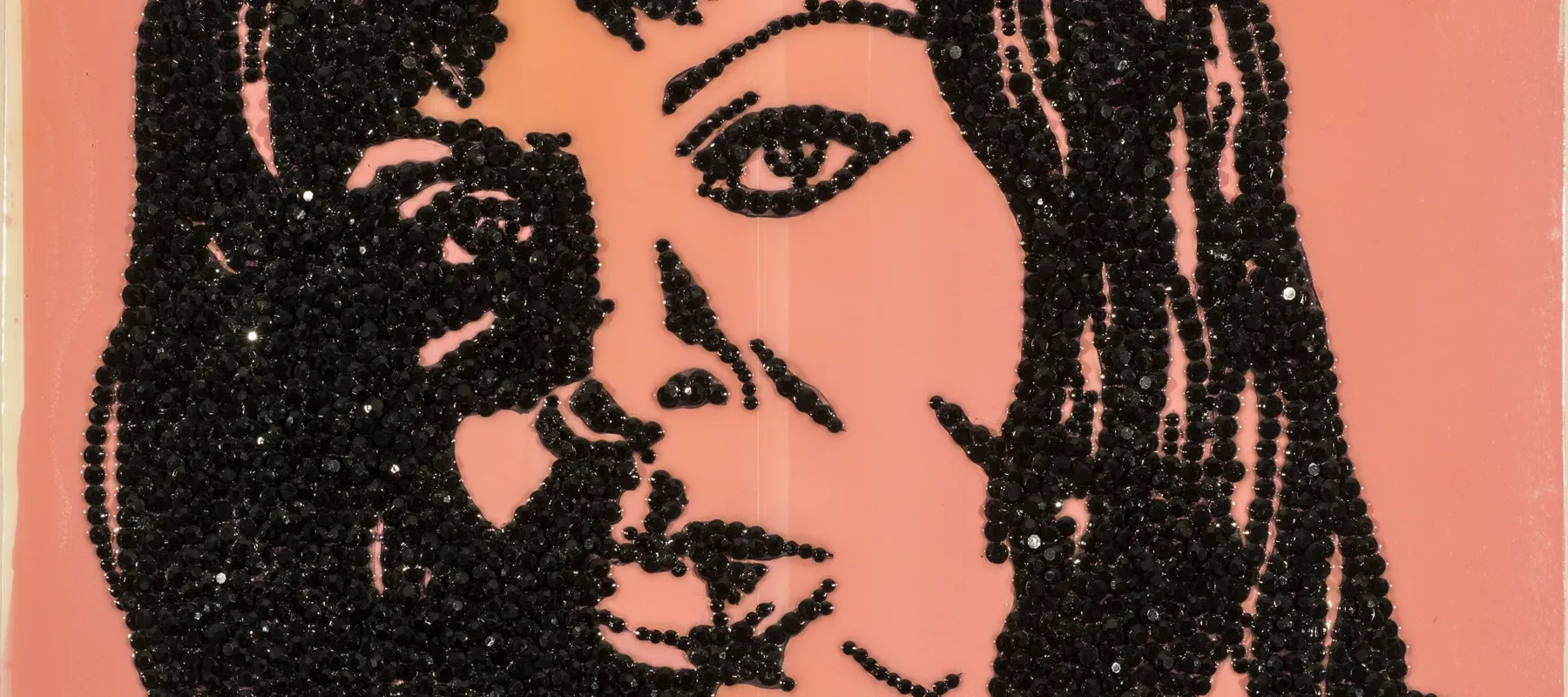 An enamel portrait painting of a woman made with encrusted black rhinestones glued to shiny pink acrylic background.