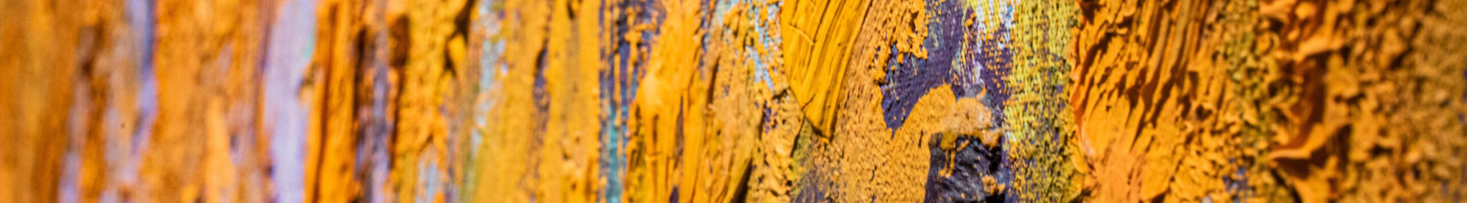Close-up detail of an abstract painting with very thick and gestural brushstrokes of mostly orange paint.