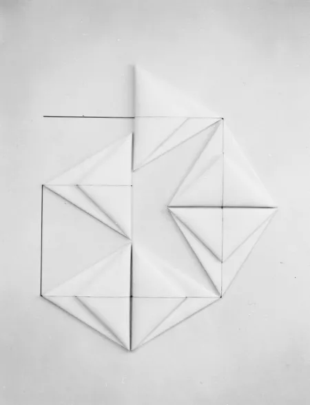 Six folded white triangles resembling origami form a large geometric shape on a white background. Connected by a continuous line that bisects their center, the corners of each triangle touch and encourage the eye to move in a circular fashion.