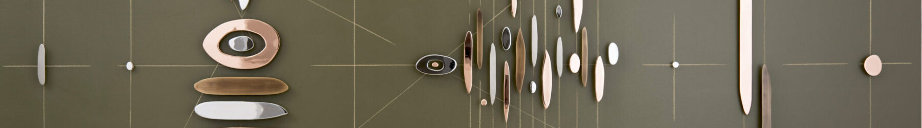 Abstract wall sculpture featuring horizontal, vertical, and diagonal intersecting lines overlaid with pieces of rounded, plated steel