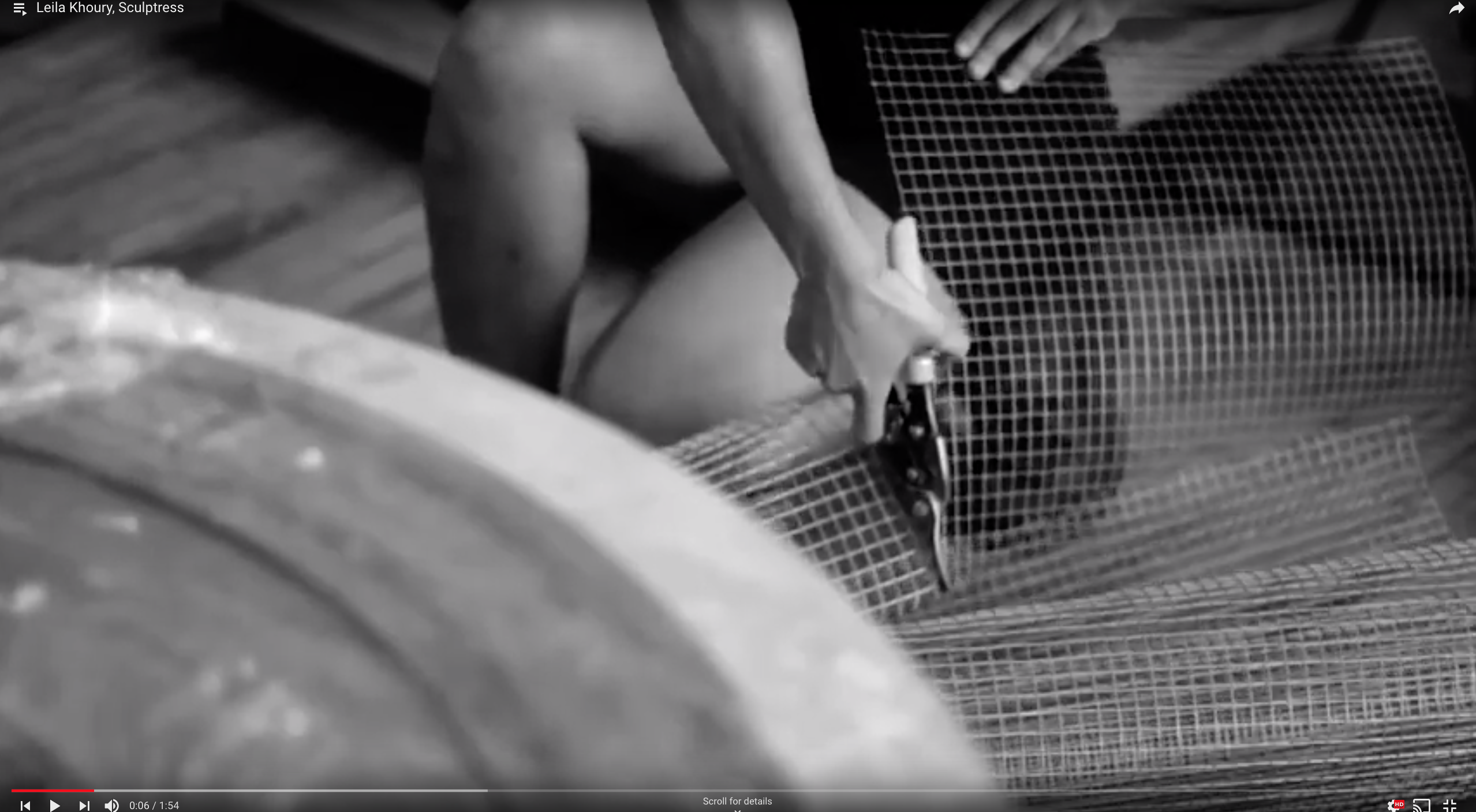 Black and white still image from a video on Leila Khoury shows the artist cutting chicken wire with clippers.