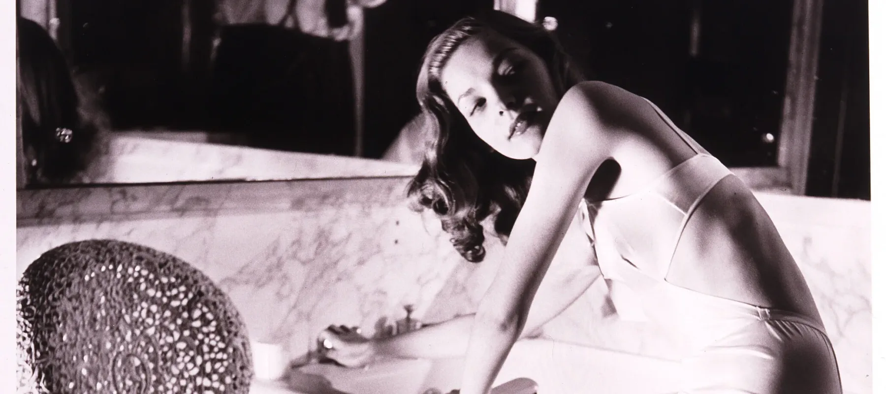 Louise Dahl-Wolfe, <em>Lauren Bacall in Helena Rubinstein's Bathroom</em>, 1943; Gelatin silver print, 14 x 11 in.; National Museum of Women in the Arts, Gift of Helen Cumming Ziegler; Photograph by Louise Dahl-Wolfe © 2023 Center for Creative Photography, Arizona Board of Regents/Artists Rights Society (ARS), New York 