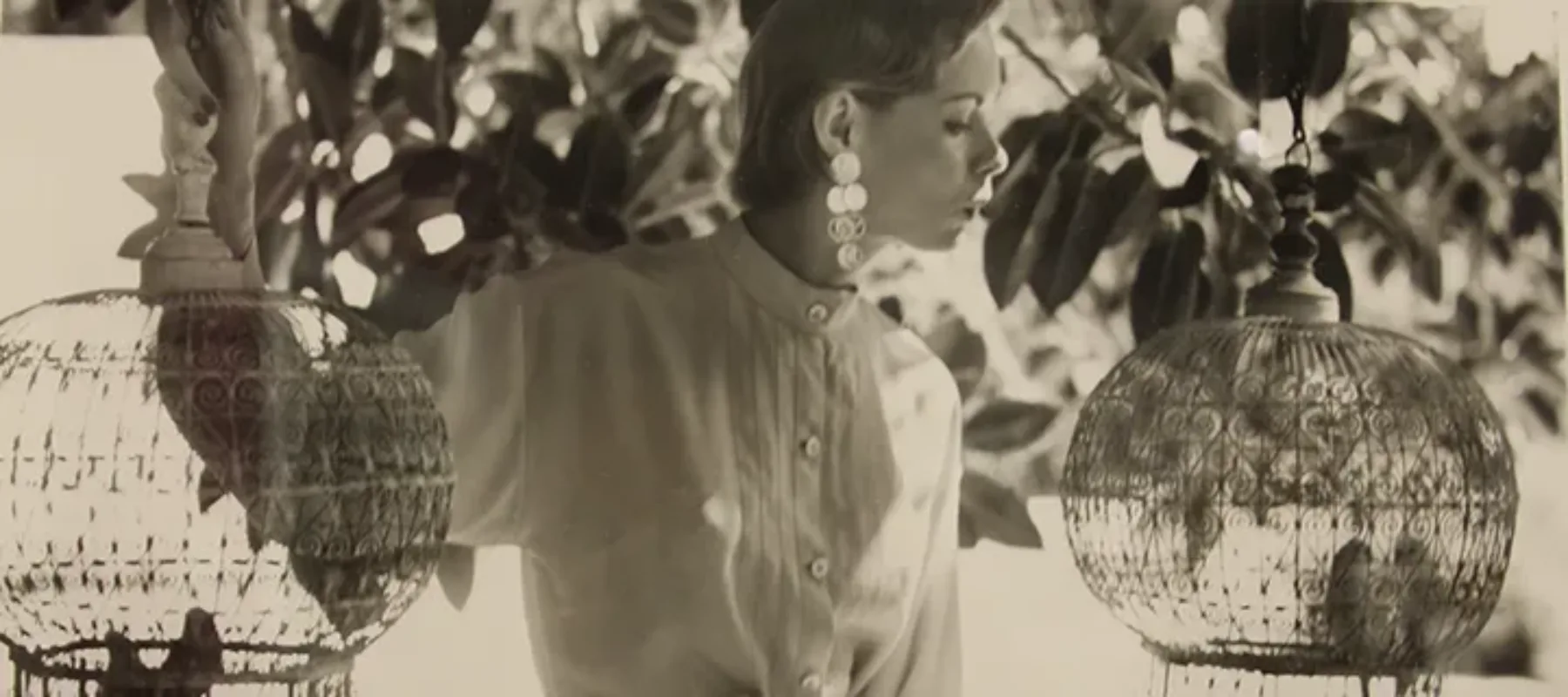 Louise Dahl-Wolfe, <i>Natalie with Birdcages</i>, 1950; Gelatin silver print 14 x 11 in.; National Museum of Women in the Arts, Gift of Helen Cumming Ziegler © 2023 Center for Creative Photography, Arizona Board of Regents/Artists Rights Society (ARS), New York 