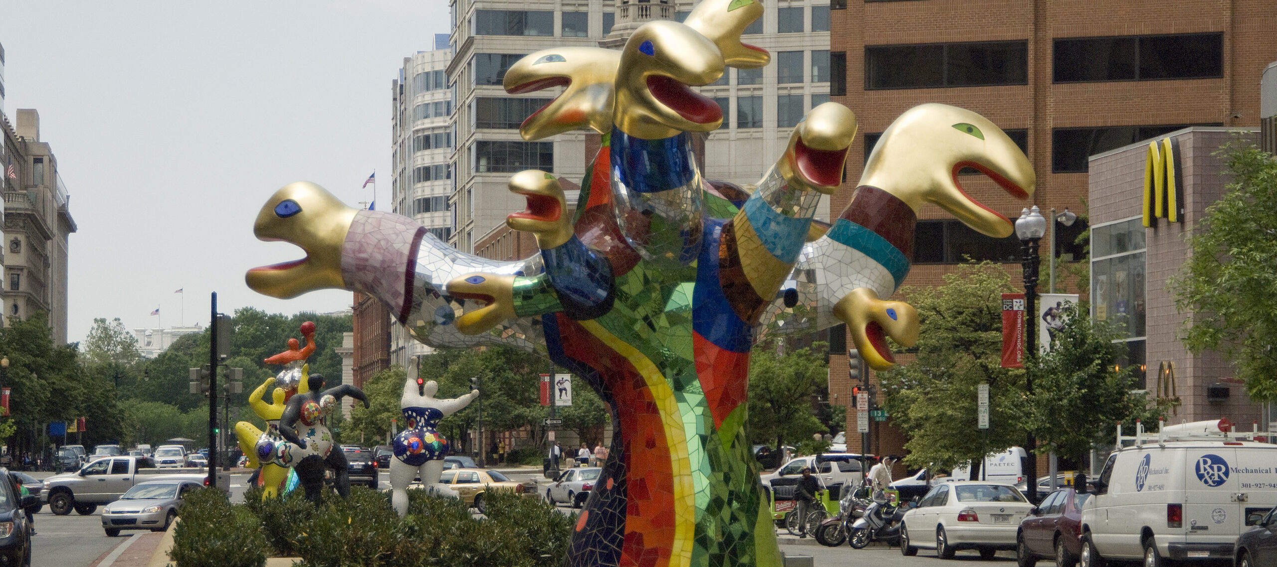 A multi-headed rainbow color snake sculpture.