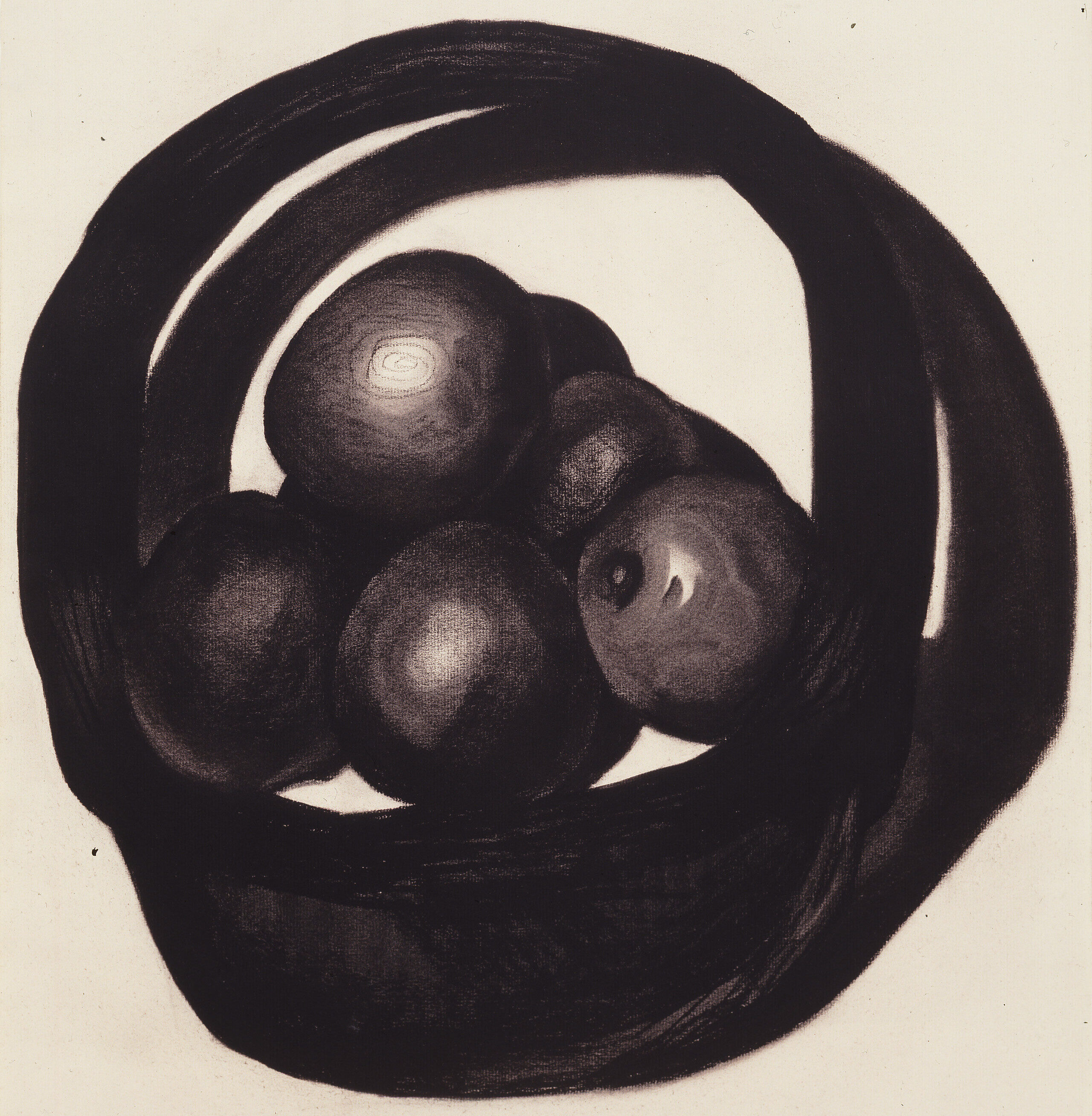 A still life of avocados in a basket rendered in charcoal on a white ground uses radically simplified forms. Two offset circles evoke a basket and its shadow. Within the circles, ovals highlighted to imply 3 dimensions, seem to hover above, not sit within, the basket interior.