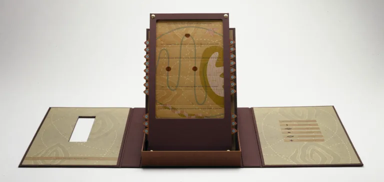 An open maroon portfolio with contents displayed upright in center. Upright panel is an abstract image with red circles connected by a curving green line on a mustard yellow background.