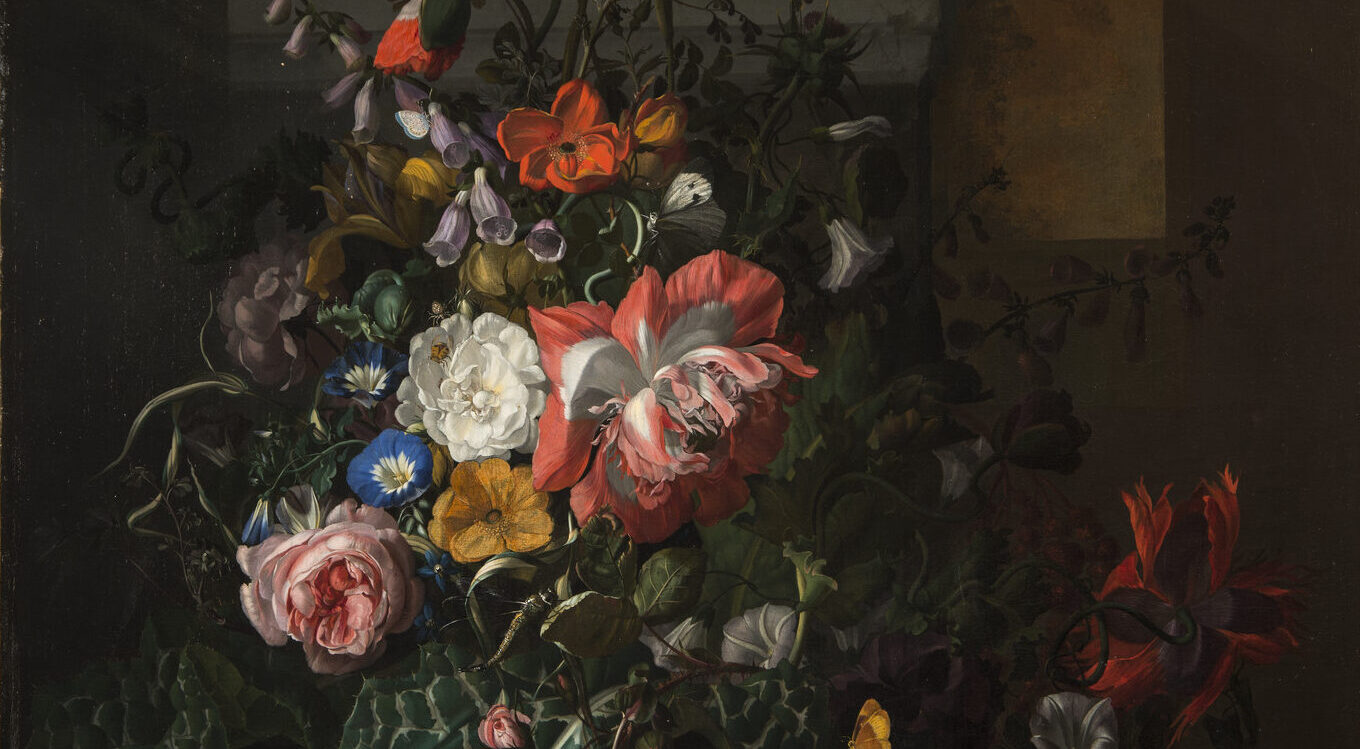 A still life painting featuring an asymmetrical arrangement of flowers; the central section features pink, orange, yellow, and blue flowers and is dramatically highlighted compared to the background and outer edge of arrangement.