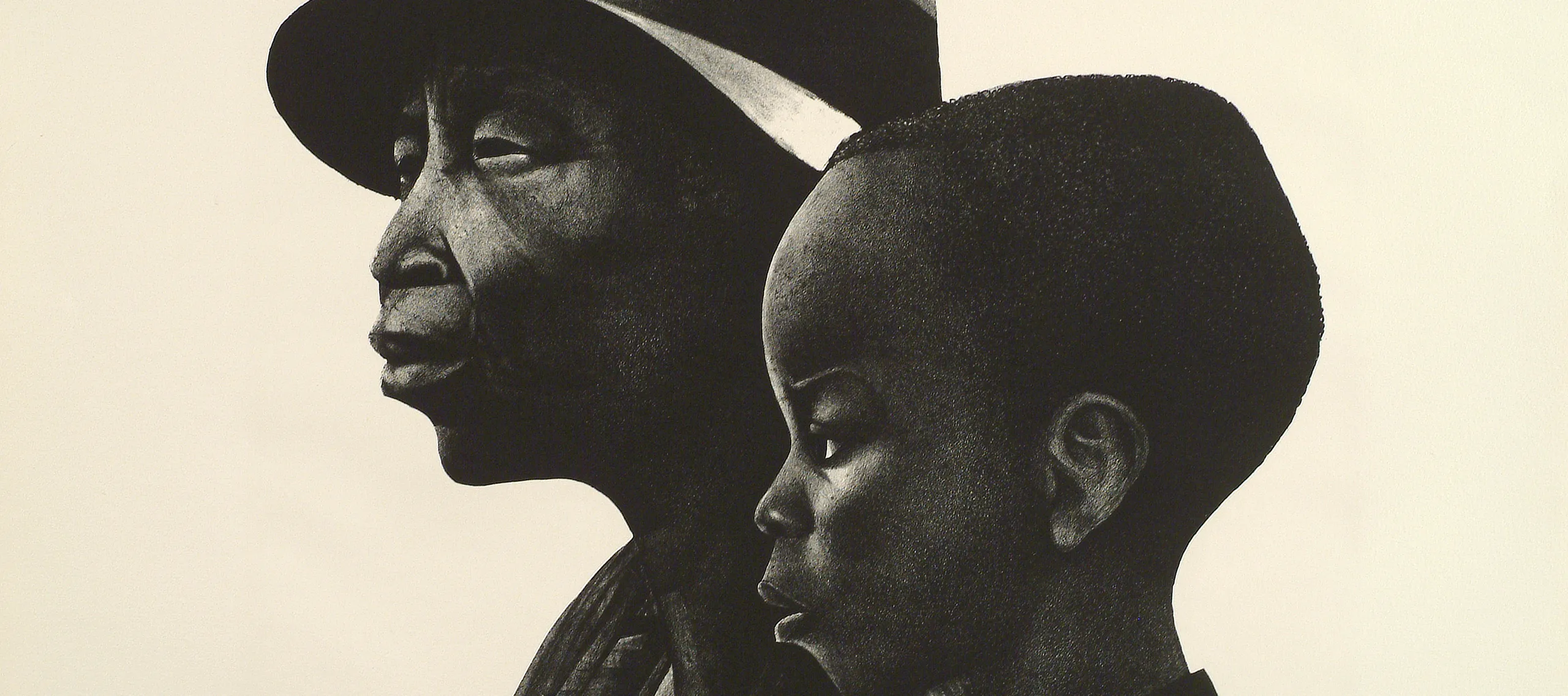 A black-and-white print of two dark-skinned individuals in profile, facing left. The person in the background is an older adult wearing a brimmed hat, and in the foreground and slightly to the right is a young child with coarse hair cut close to the head.