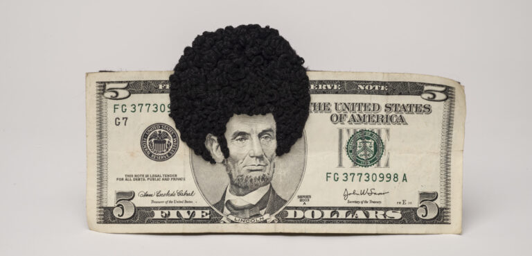 U.S. five-dollar bill has an embroidered afro and sideburns stitched onto the portrait of Lincoln’s head. One-third of the afro protrudes beyond the top of the bill.