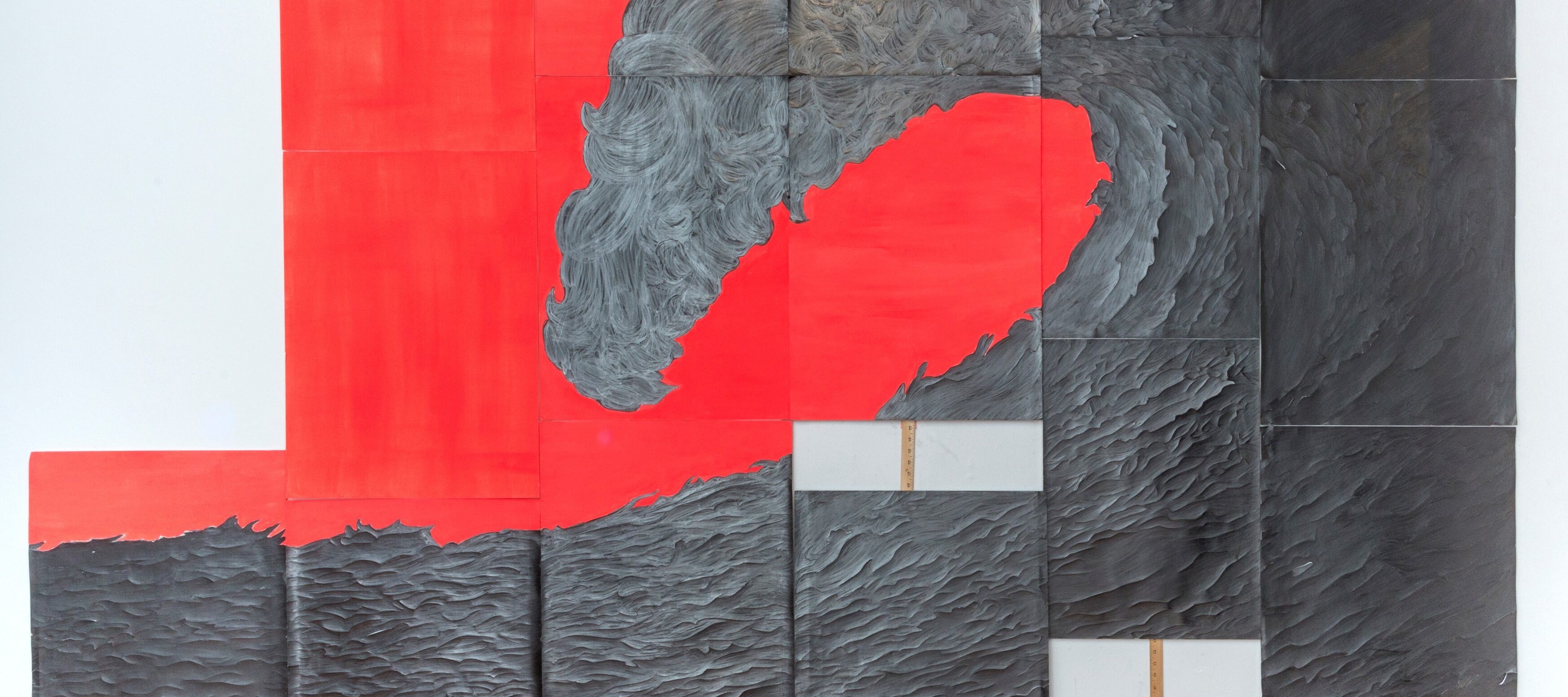 Six rectangular panels of varying heights with a coral background are hung together on a wall with yardsticks attached to the bottoms of each panel. Each panel includes a part of a textured graphite drawing that looks like a giant crashing wave when seen as a whole.
