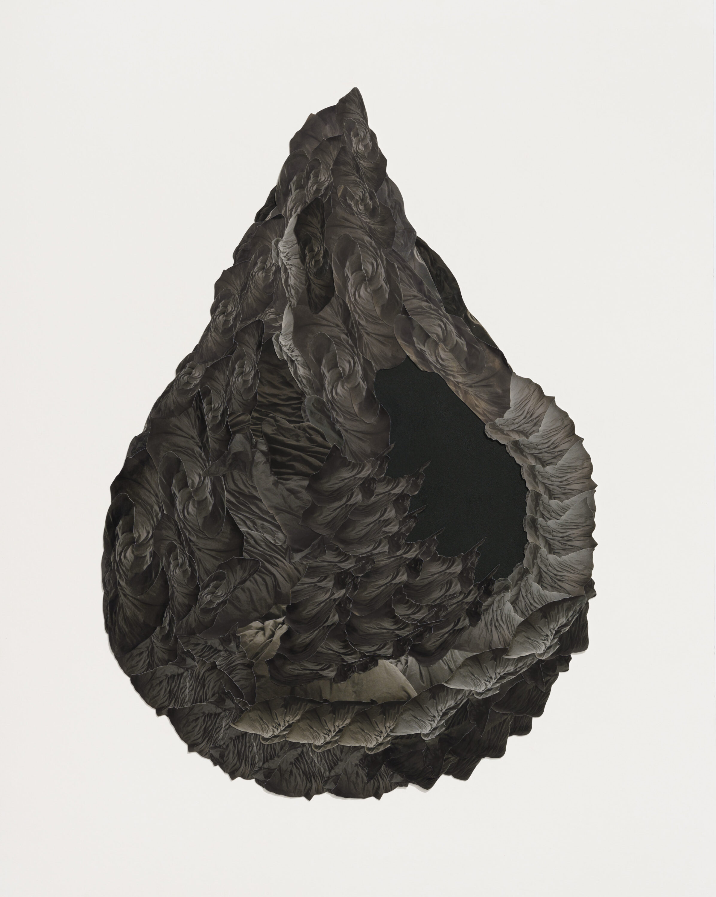 A black work in the shape of a teardrop on a white background. The object has cavernous textures on its surface.