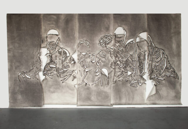Five panels of paper covered in gray charcoal in which there is a cut stencil of an image of a group of faceless people. The panels have portions of paper that flap and fold.