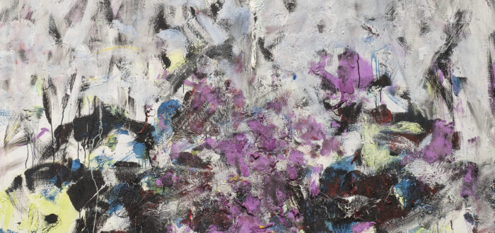 A vertical, abstraction features broadly painted strokes of pale gray, lavender, and cobalt in the upper two-thirds of the canvas. The colors continue in the lower third, along with touches of green, black, and other hues, but the expressive brushwork becomes denser and chaotic.