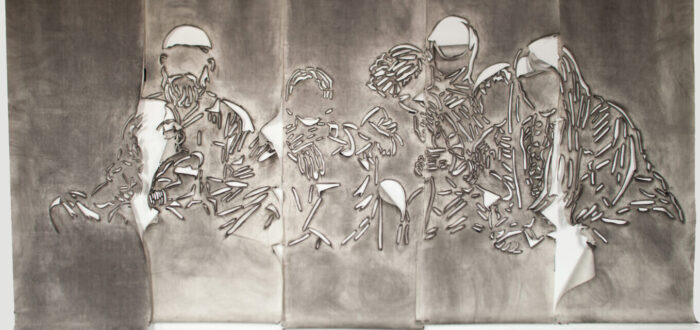 Five panels of paper covered in gray charcoal in which there is a cut stencil of an image of a group of faceless people. The panels have portions of paper that flap and fold.